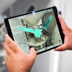 Researcher holds a tablet while using the augmented reality app.